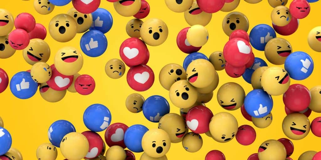 Emojik labdaként egy sárga háttér előtt.